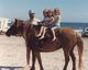 Riding "Booboo" at the beach.